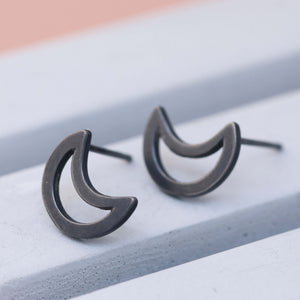 Oxidised black silver moon earrings on grey dish, bold moon stud earrings