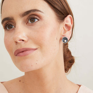 Model wearing Signature Black Pearl Stud Earrings in oxidised sterling silver with genuine freshwater pearls. 