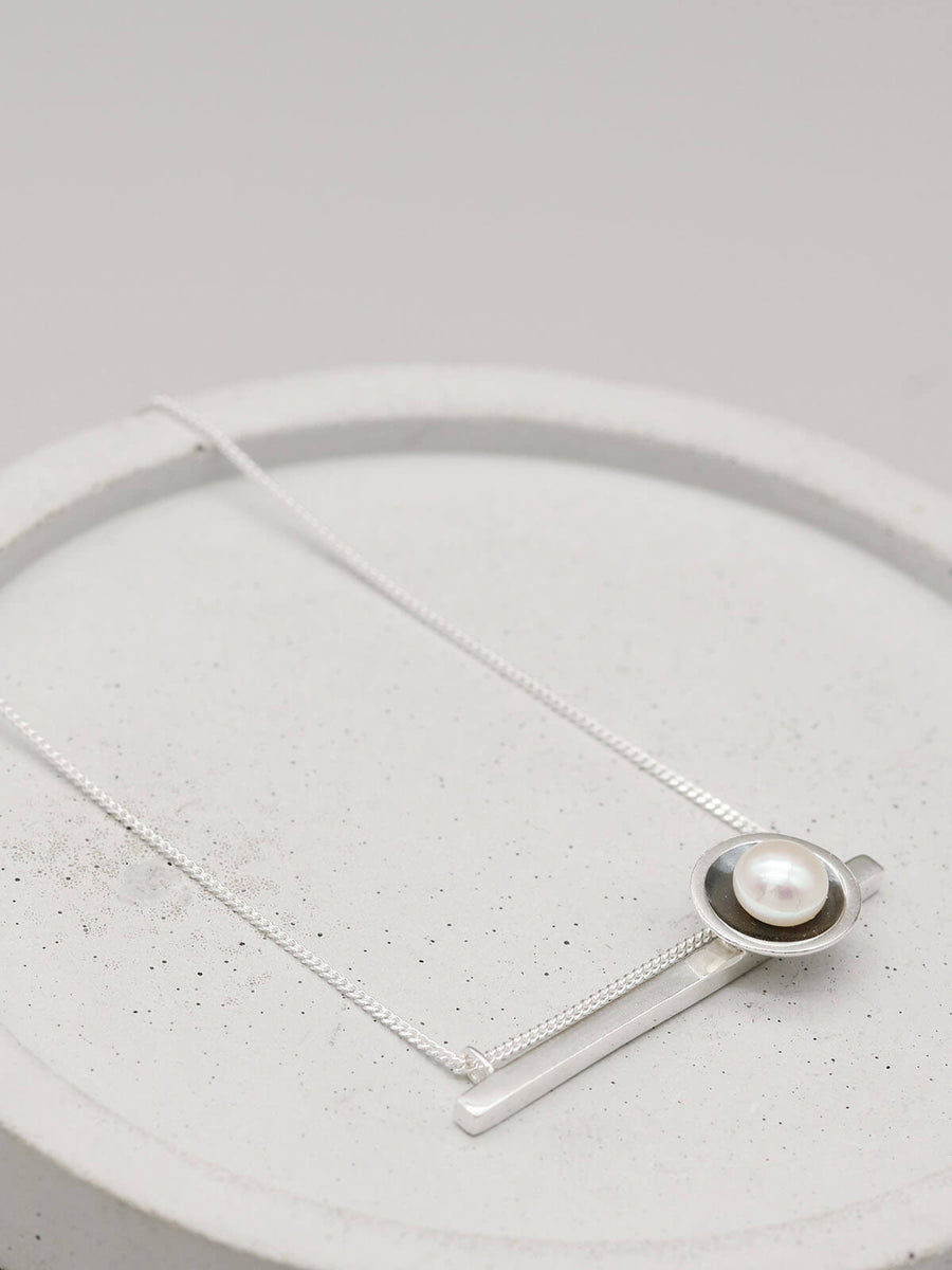 Oxidised sterling silver geometric pearl necklace featuring a horizontal bar and genuine freshwater pearl.