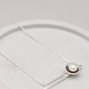 Oxidised sterling silver geometric pearl necklace featuring a horizontal bar and genuine freshwater pearl.