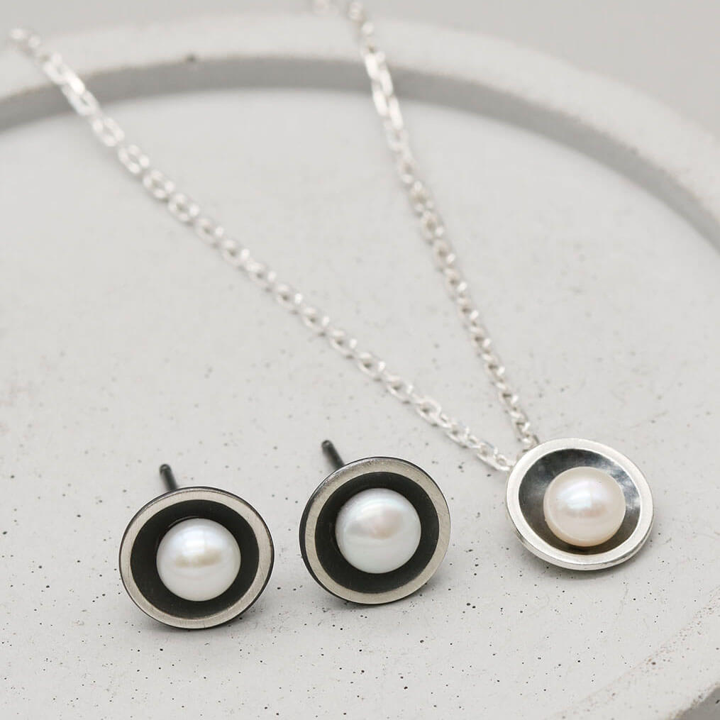 Handmade oxidised sterling silver pearl pendant necklace paired with coordinating black pearl stud earrings.