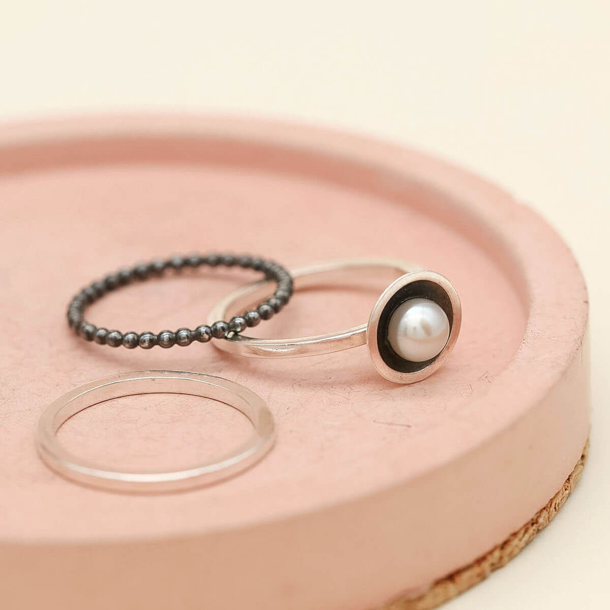 Modern pearl ring set featuring three handmade sterling silver stacking rings