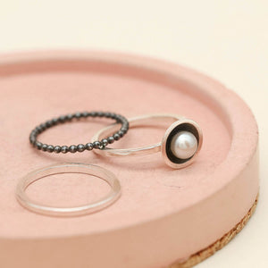Modern pearl ring set featuring three handmade sterling silver stacking rings