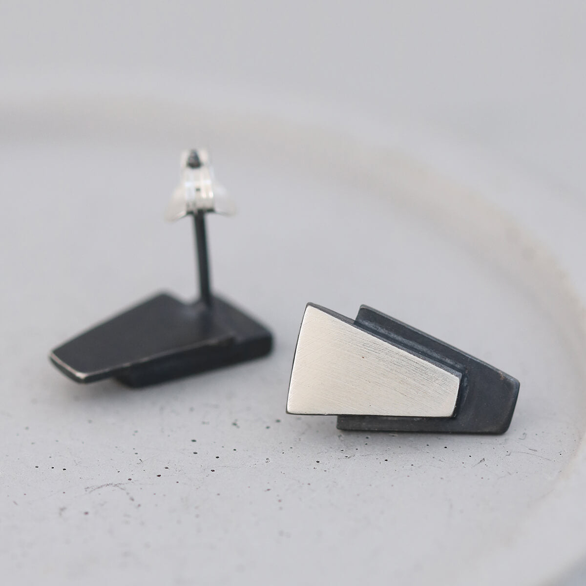 Sterling silver black earrings with geometric design on a grey dish, perfect gift for her for Christmas or special celebrations.