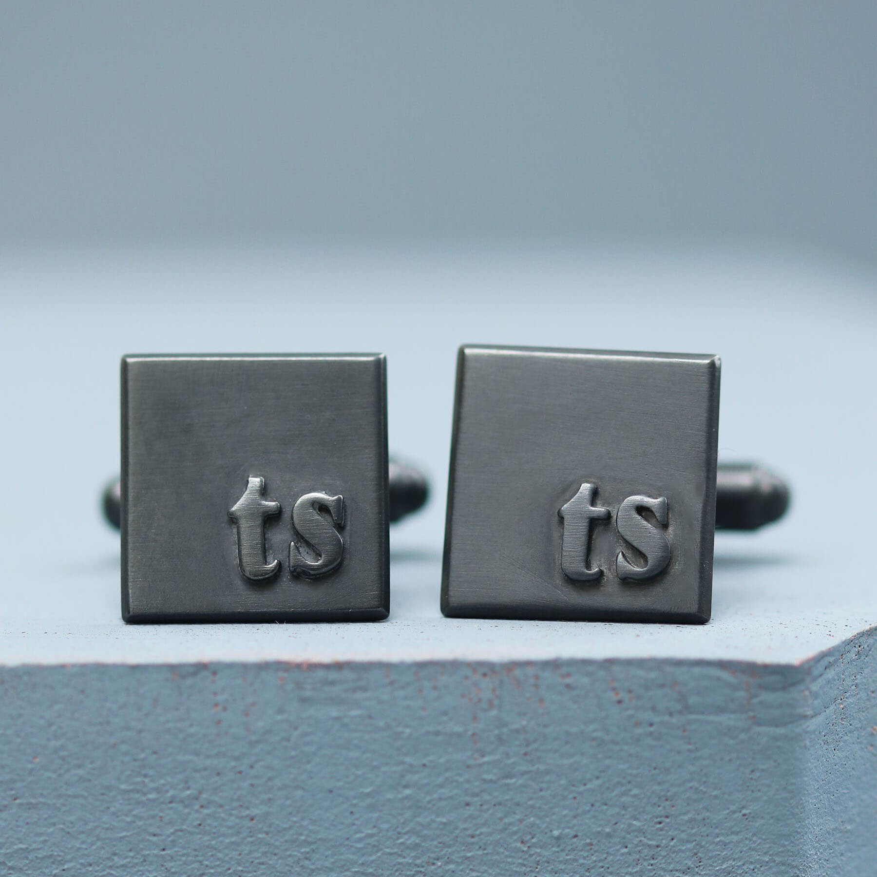 Initial cufflinks with TS initials in sterling silver, personalised cufflinks for a wedding gift, on a deep blue background