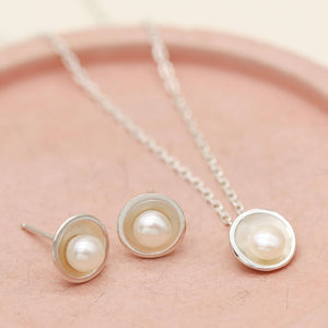 Coordinating sterling silver pearl pendant and matching freshwater pearl stud earrings handcrafted in sterling silver.