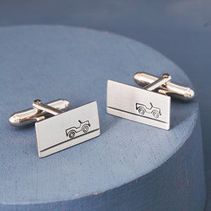 Pair of sterling silver land rover cufflinks photographed on a deep blue background, perfect car enthusiast gifts for Father’s Day or birthdays.