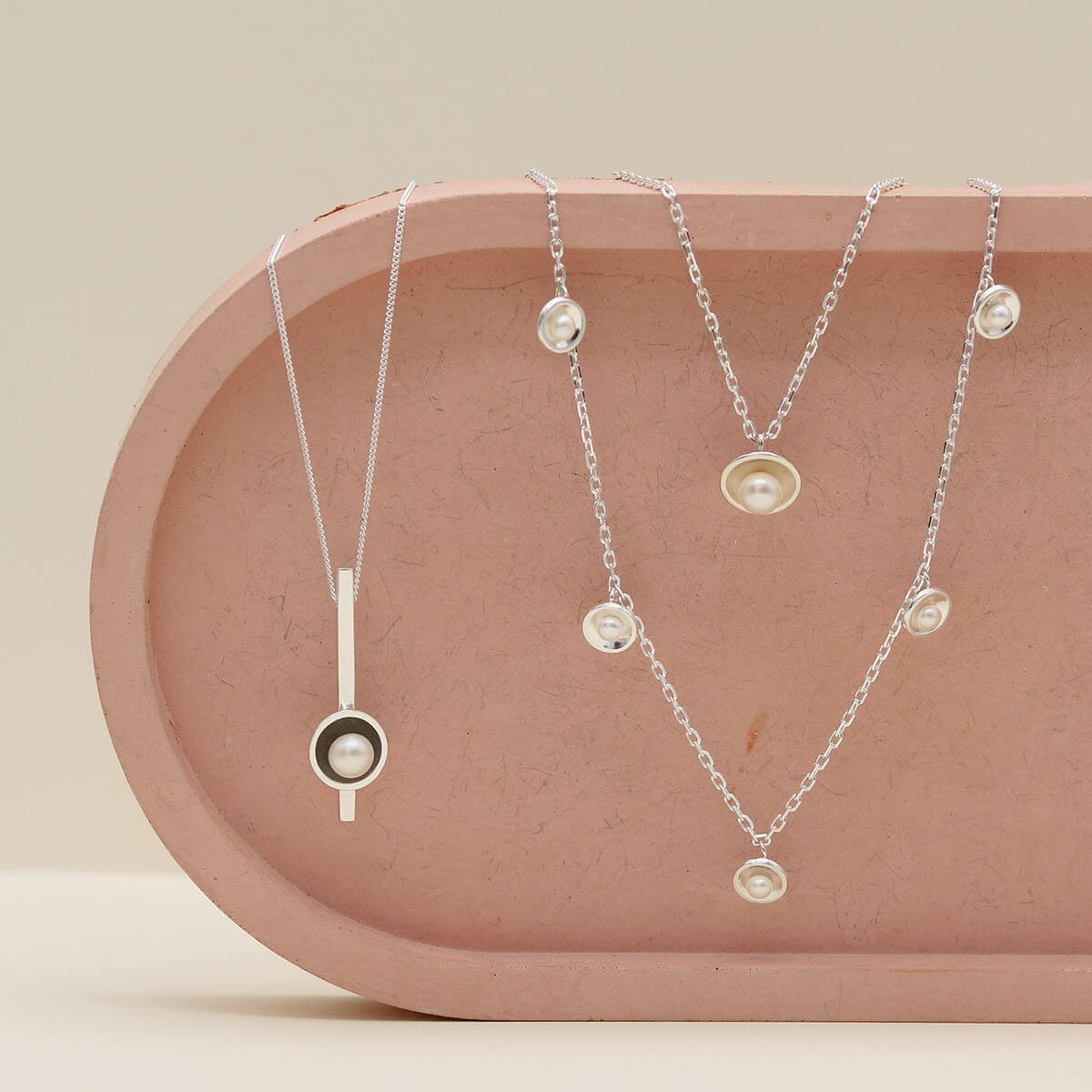 Sterling silver pearl chain necklace photographed with the original pearl pendant necklace and the long pearl bar necklace, showcasing complementary layering styles.