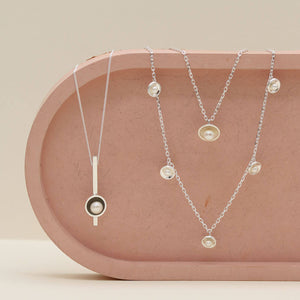 Sterling silver pearl chain necklace photographed with the original pearl pendant necklace and the long pearl bar necklace, showcasing complementary layering styles.