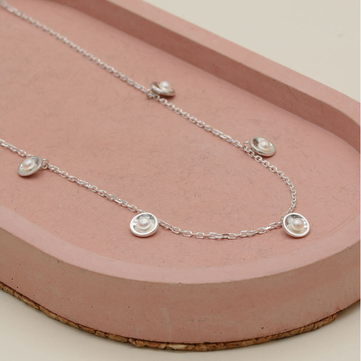 Chain necklace with pearls crafted in solid sterling silver, featuring five small freshwater pearls evenly spaced along the chain.