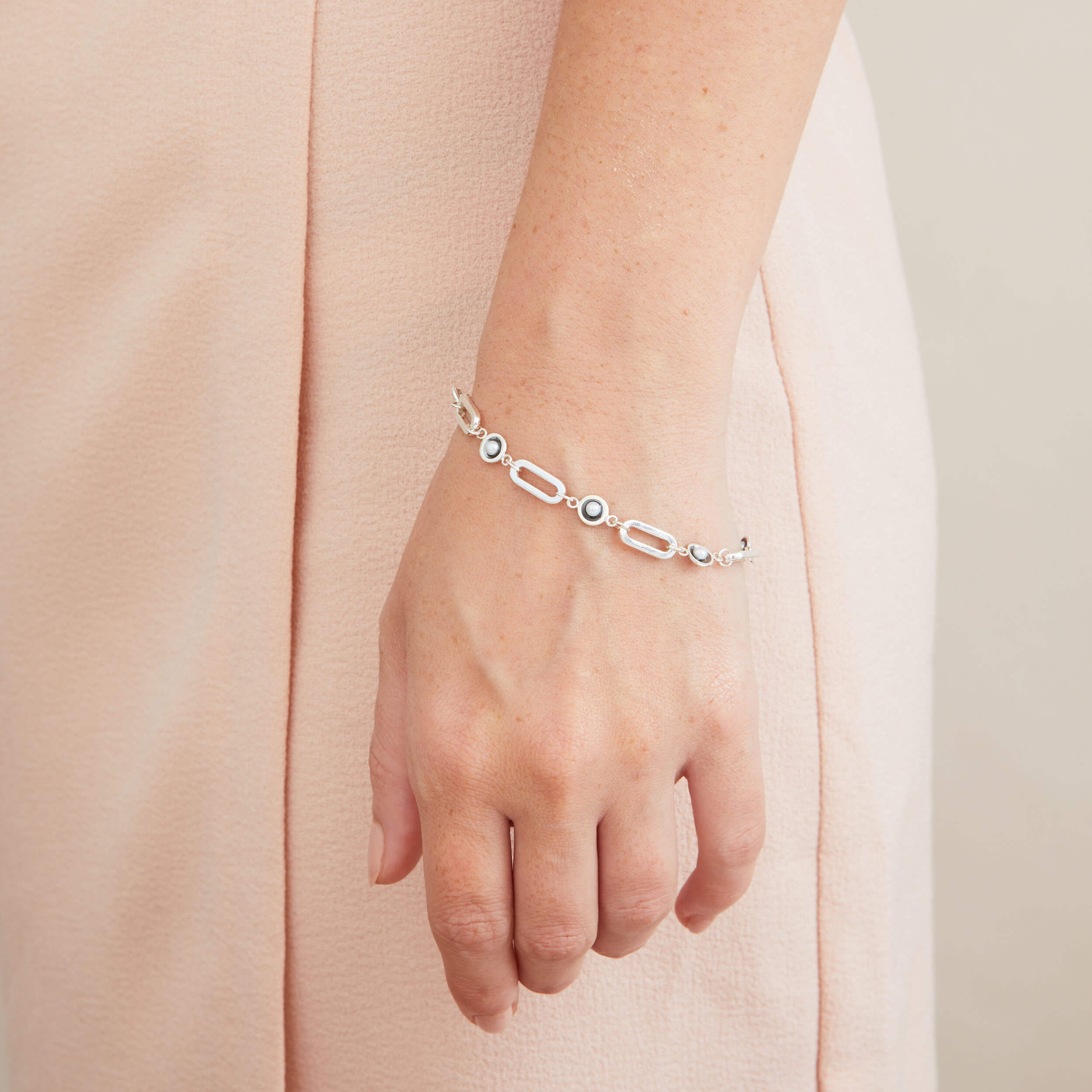 Black pearl chain bracelet worn as a statement bracelet, featuring bold sterling silver links and genuine freshwater pearls.