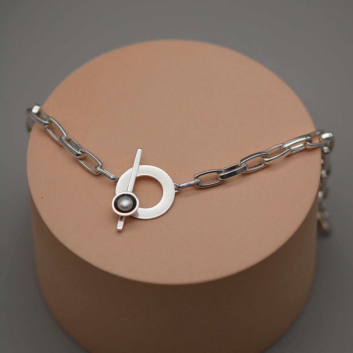 Handmade pearl statement necklace featuring a substantial sterling silver rectangular trace chain and freshwater pearl in an Art Deco inspired setting.