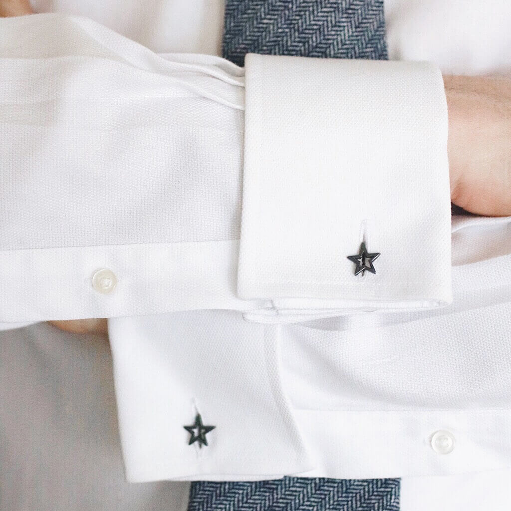 Matte black Star cufflinks being worn on a cuff – bold and stylish, an ideal graduation gift for son or modern formalwear upgrade.