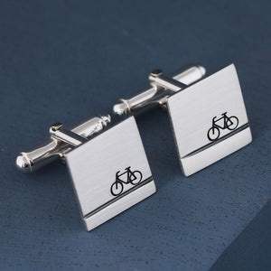 Detailed shot of sterling silver bike cufflinks with hand-stamped bicycle motif, cycling gifts for him for Father’s Day or wedding mornings.