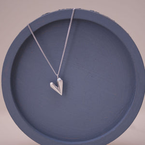 Sterling silver heart shaped necklace on a blue dish, a dainty heart necklace ideal for birthdays anniversaries or romantic gifts