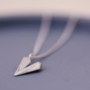 Sterling silver heart shaped necklace on a blue dish, a dainty heart necklace ideal for birthdays anniversaries or romantic gifts