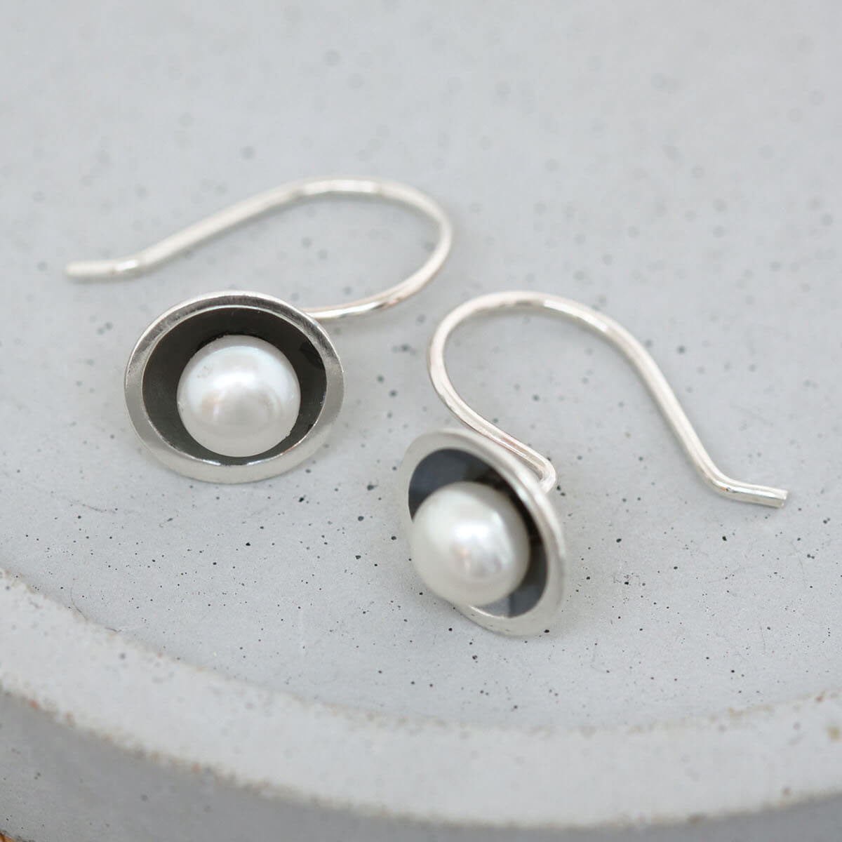 Art Deco-inspired black pearl drop earrings with genuine freshwater pearls in handcrafted sterling silver settings.