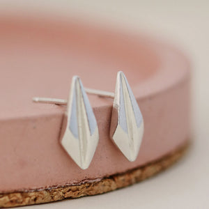 Close-up of art deco stud earrings on a soft pink dish, highlighting the clean lines of these art deco style earrings perfect for birthdays or bridal gifts.