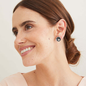 Signature black pearl stud earrings worn to show their elegant size between the Classic and Statement designs. 