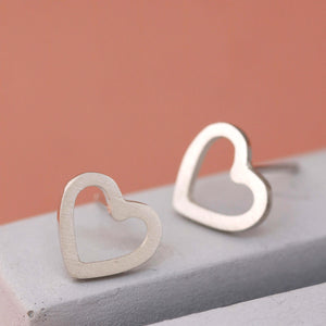 Matte heart sterling silver earrings on grey dish, elegant heart shaped silver earrings