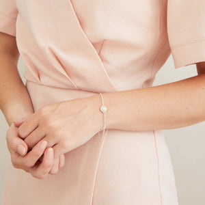 Sterling silver and pearl bracelet worn as a stacking bracelet alongside other sterling silver jewellery for a contemporary layered look.