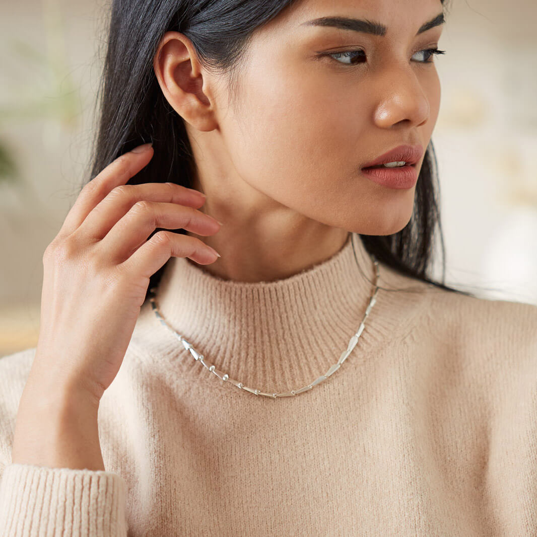 Contemporary silver link necklace styled over a soft turtleneck knit, a versatile link necklace that makes a timeless Christmas or birthday gift for her.
