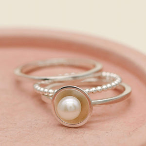Stacking rings for women featuring a freshwater pearl solitaire ring and silver bands
