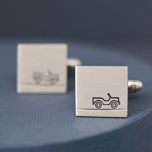 Side view of Car cufflinks on deep blue background showing matte silver texture, a stylish and understated gift for car lovers.