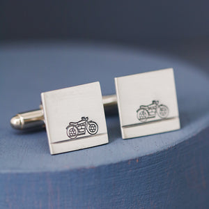 Modern sterling silver motorbike cufflinks on deep blue background, perfect graduation gift for motorbike enthusiasts