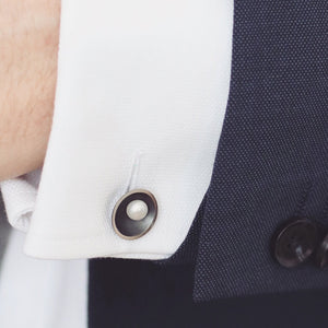 Black pearl cufflinks with oxidised silver finish worn with formal menswear and white shirt.