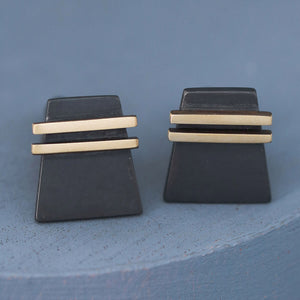 Side view of handcrafted Black and Gold cufflinks on deep blue background, a stylish pair of special cufflinks for birthdays or Father’s Day.