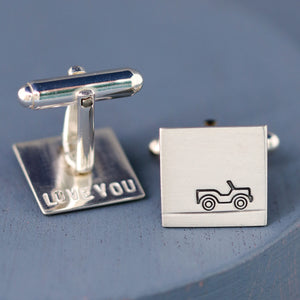 Car cufflinks arranged at an angle on blue background to highlight geometric shape and car stamp, great gift for car lovers and Dads.