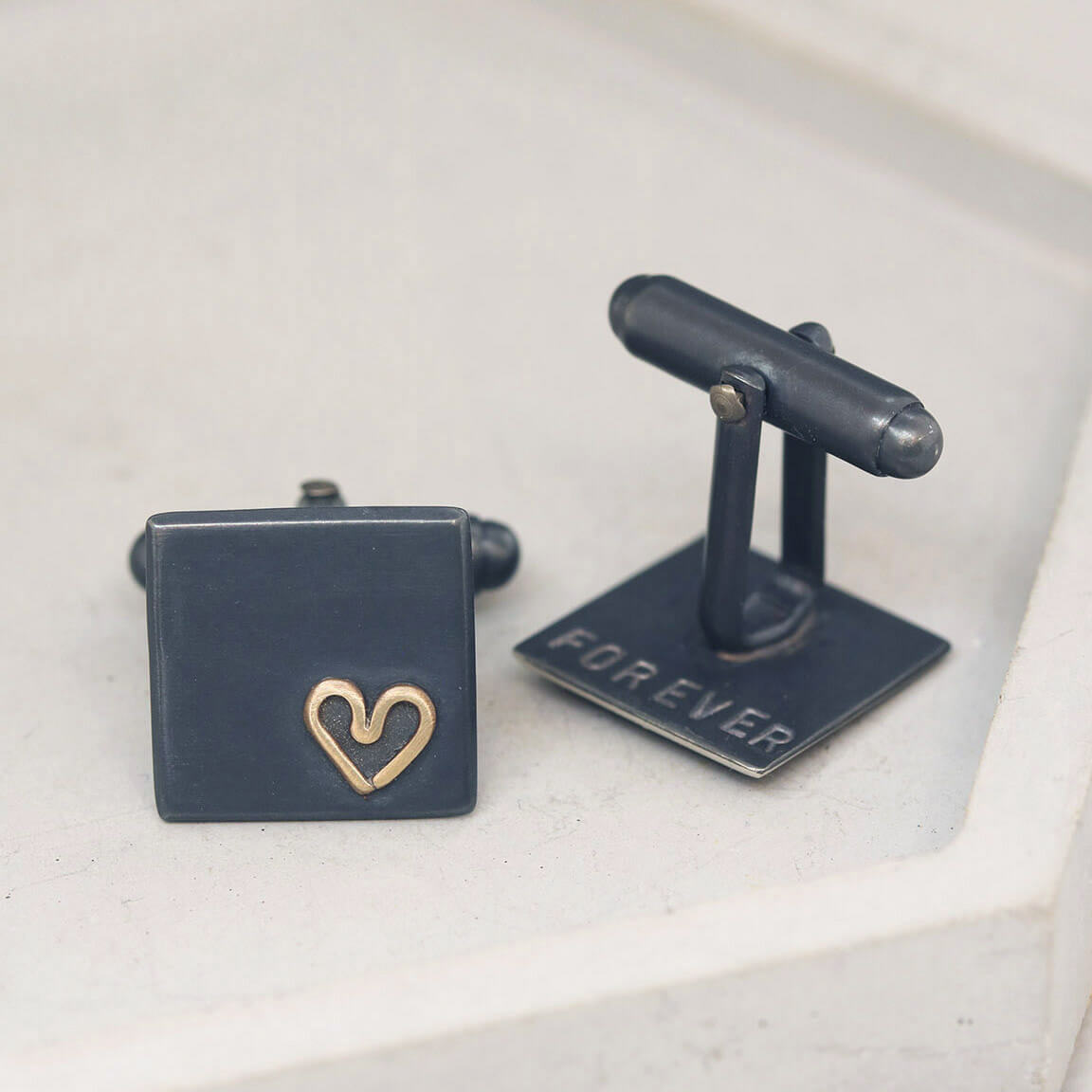 One cufflink turned to show hand-stamped personalisation on reverse, romantic Groom wedding cufflinks in silver and gold.
