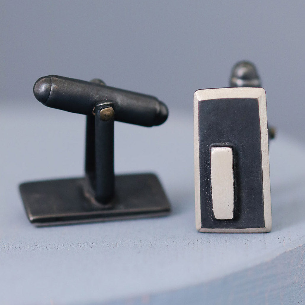 Side-on view of black and silver cufflinks, showing the sturdy fittings and sleek design, perfect for formal wear or special birthday gifts for husband.