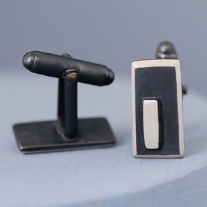 Side-on view of black and silver cufflinks, showing the sturdy fittings and sleek design, perfect for formal wear or special birthday gifts for husband.