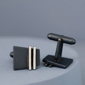 Both black cufflinks displayed at an angle to show depth and craftsmanship. Stylish accessory for weddings, birthdays, or promotions.