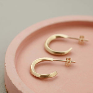 Real gold small hoop earrings flat lay on pink dish, 9ct hoop earrings luxury gift for her