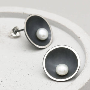 Contemporary black pearl stud earrings handcrafted in oxidised sterling silver with an Art Deco-inspired domed design.