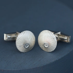 Sunburst engraved round cufflinks packaged on deep blue background – sterling silver cufflinks for graduation or promotion gift.