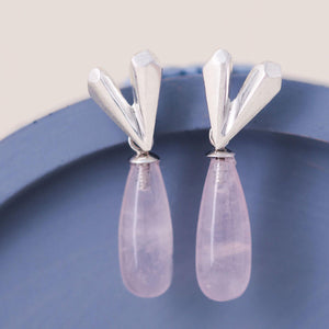 Heart dangle earrings with faceted sterling silver heart and rose quartz drop displayed on a blue dish, Pink heart earrings handmade in silver