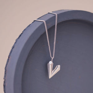 Dainty heart necklace on a blue dish, minimalist sterling silver heart shaped necklace perfect for everyday wear