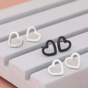 Heart sterling silver earrings in polished, matte and oxidised finishes on grey dish