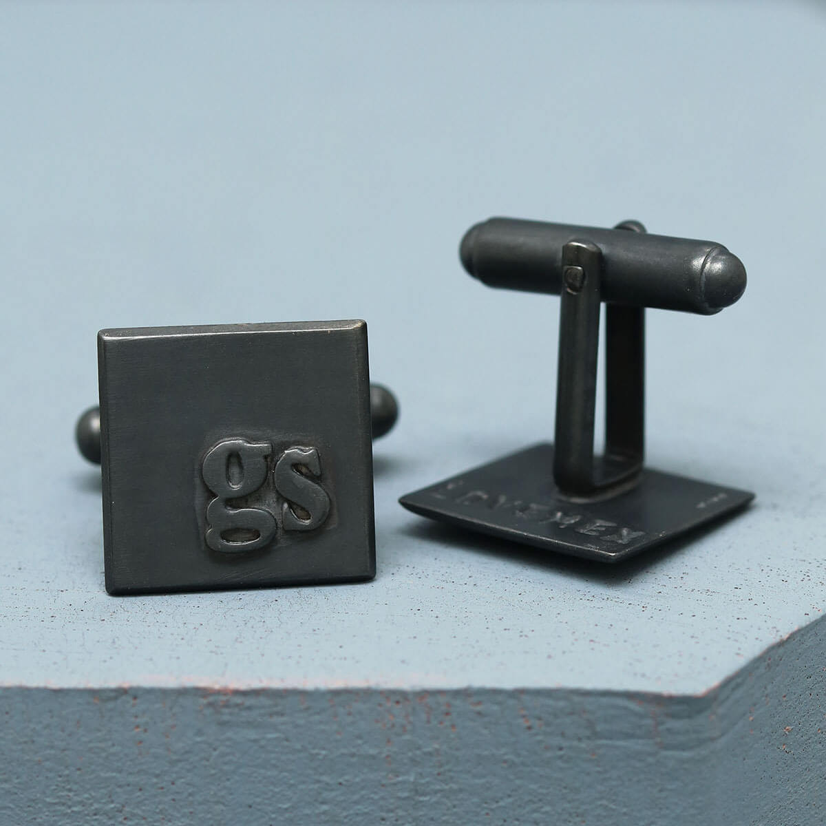 Initial cufflinks with GS initials in sterling silver, personalised cufflinks for a wedding gift, on a deep blue background