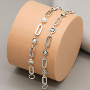 Sterling silver and black pearl chain bracelets displayed together, showcasing polished and oxidised sterling silver settings with genuine freshwater pearls.