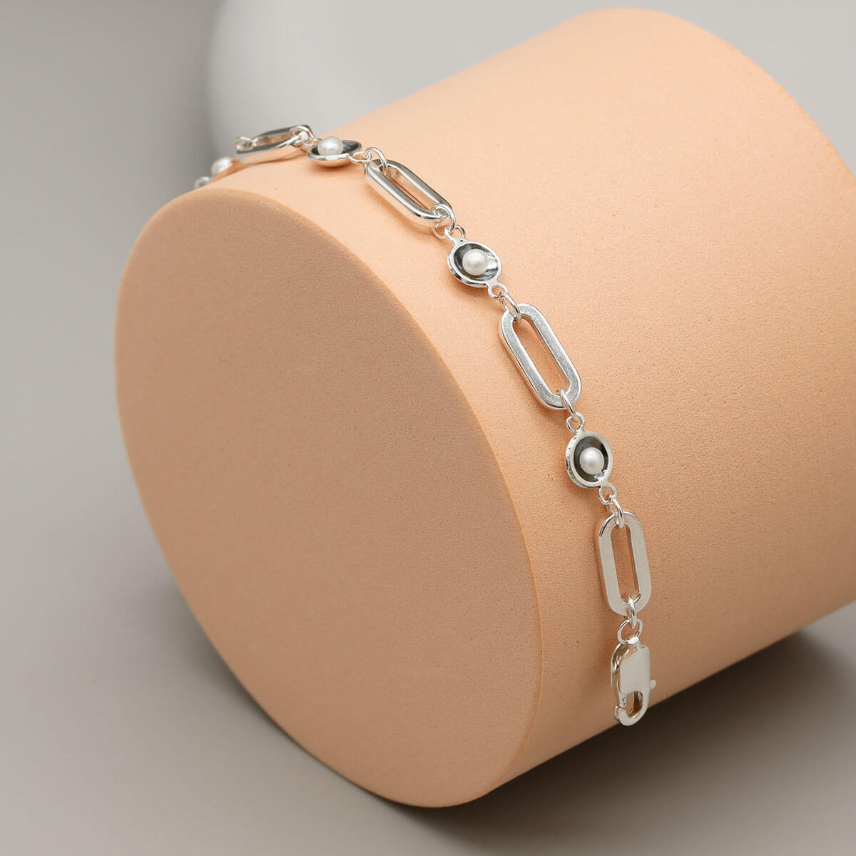 Art Deco inspired black pearl bracelet handcrafted in sterling silver with five freshwater pearls and bold rectangular chain links.