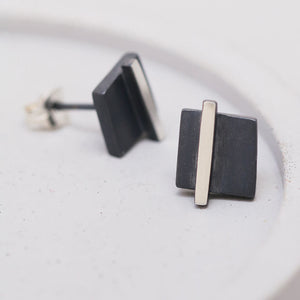 Small black stud earrings on a grey dish highlighting the oxidised detail, perfect Christmas gift for women.