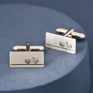Handmade land rover cufflinks in sterling silver photographed against blue background, perfect gift for car fans on birthdays or Christmas.