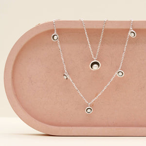 Black pearl chain necklace layered with the original black pearl pendant necklace, showing how the delicate pearl stations complement a classic pearl pendant.