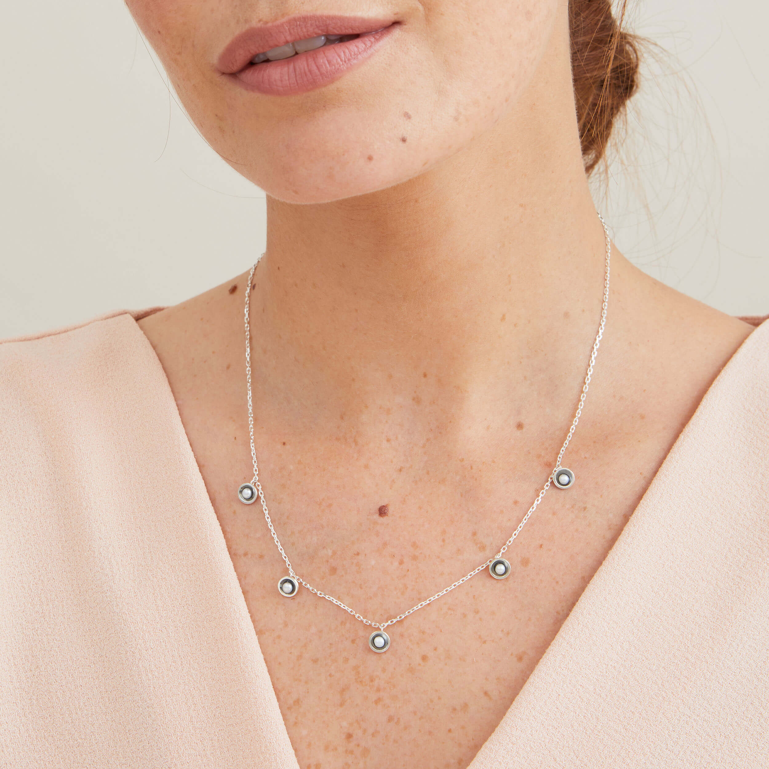 Delicate mini pearl necklace in oxidised sterling silver worn layered at the neckline for a contemporary look.