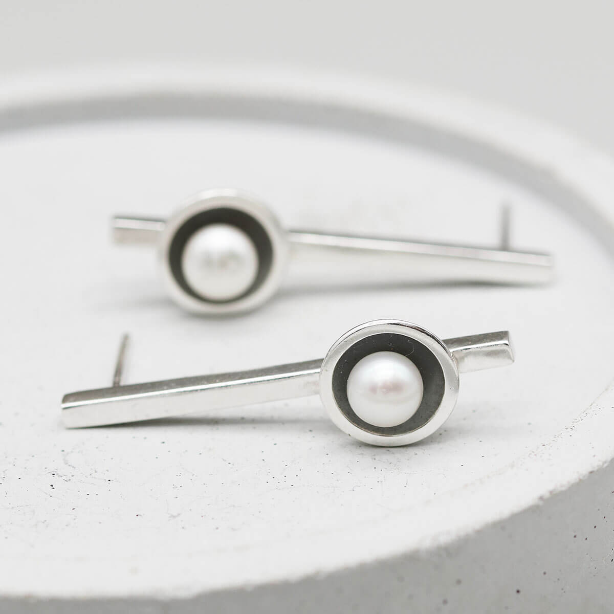 Contemporary long black pearl earrings featuring a 30mm sterling silver bar and genuine freshwater pearls.